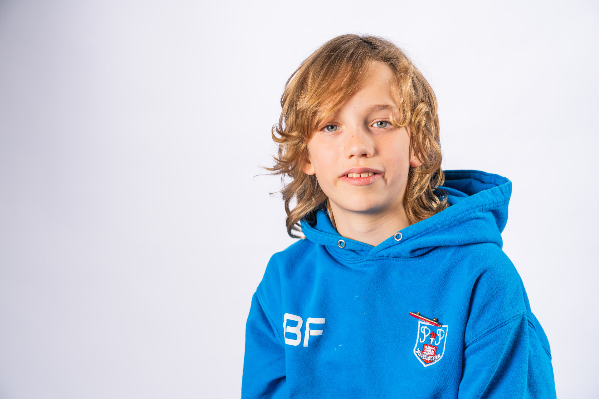 Individual school portrait - boy in blue school hoodie