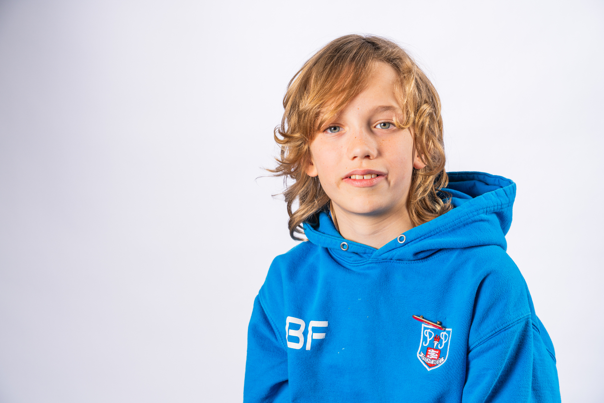 Individual school portrait - boy in blue school hoodie